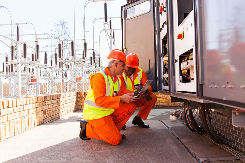 Electricians working on construction site Image