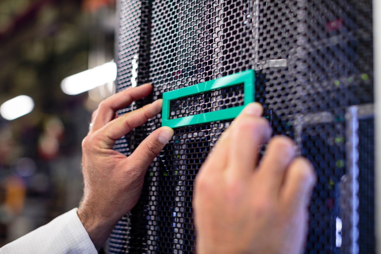 Close up of man holding logo on Synergy server rack door