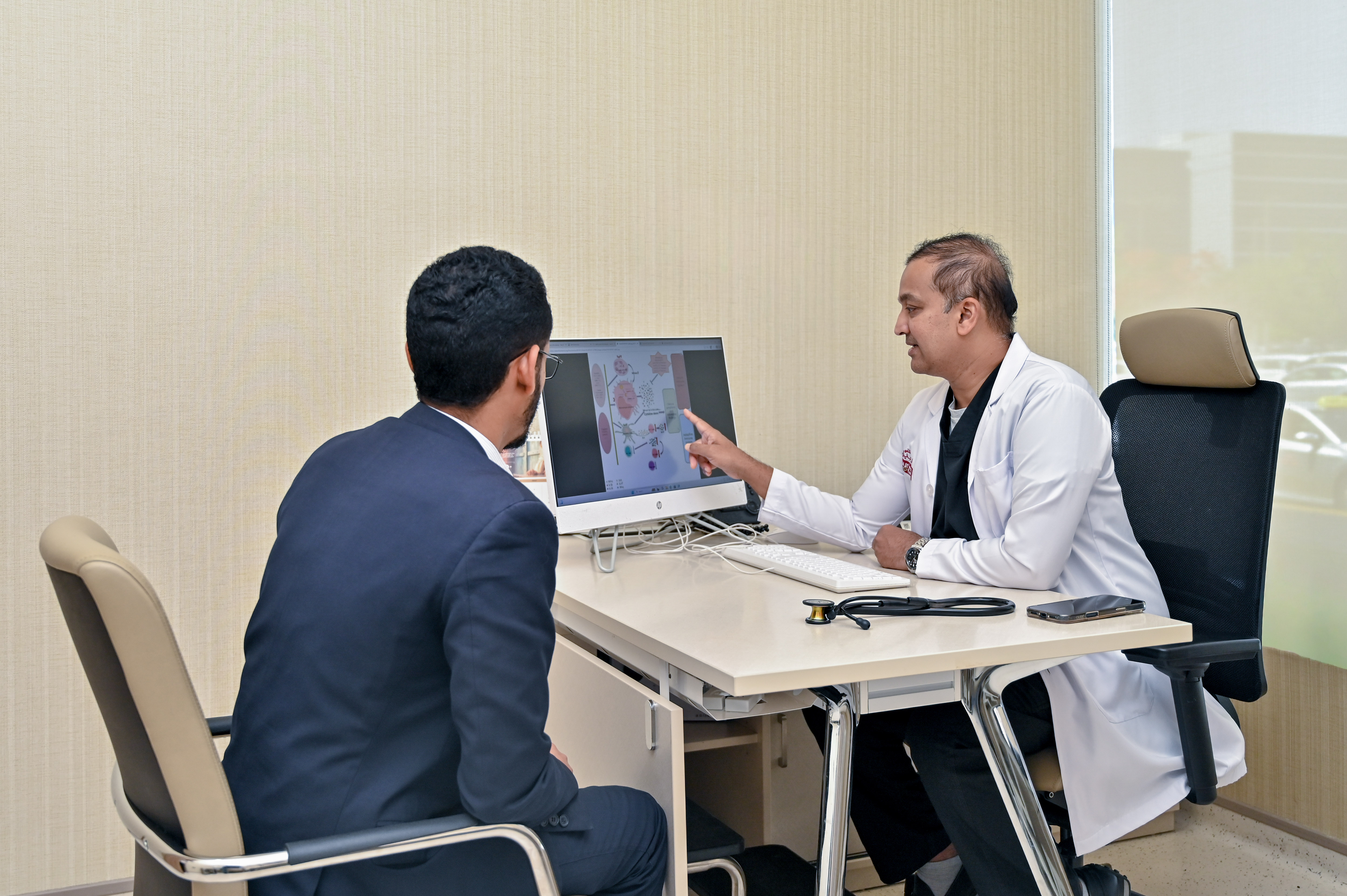 Dr. Niyas Khalid with the patient who was successfully treated for Adult-Onset Still’s Disease.jpg
